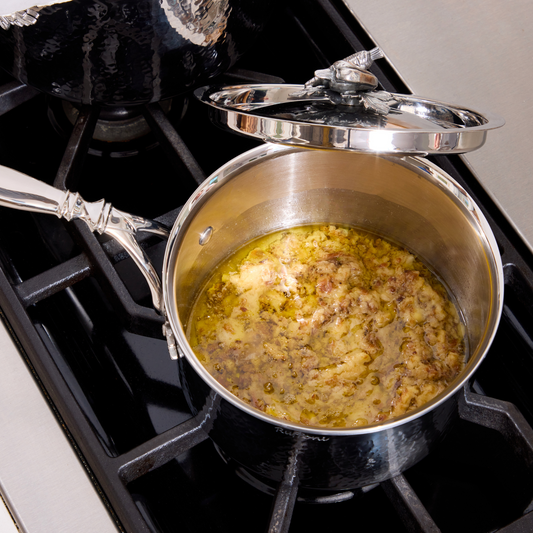 Bagna cauda in an Opus Prima hammered clad stainless steel saucepan with decorated silver-plated lid knob finial from Ruffoni.