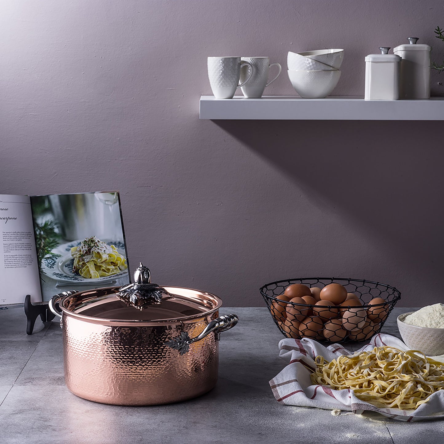 Ruffoni Opus Cupra stockpot in the kitchen with fresh pasta, flour, and eggs