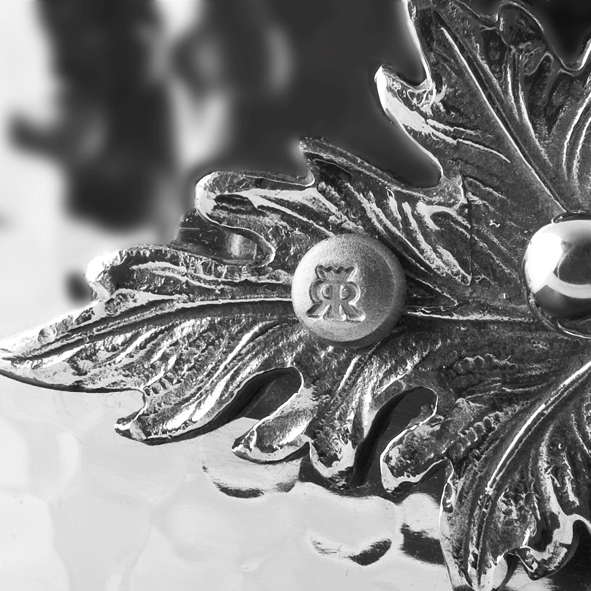 Details of the Opus Prima hammered clad stainless steel chef pan with decorated silver-plated lid knob finial from Ruffoni