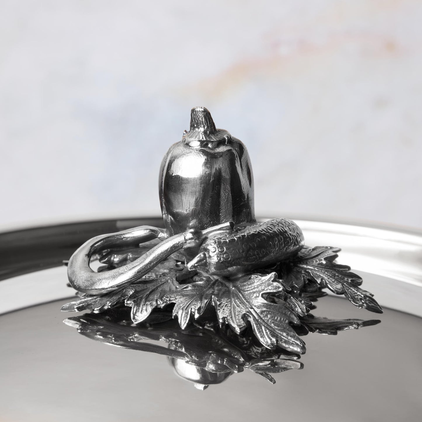 Decorated knob finial representing pepper, cucumber, string bean, cast in solid bronze and silver plated, on Opus Prima stainless steel lid by Ruffoni