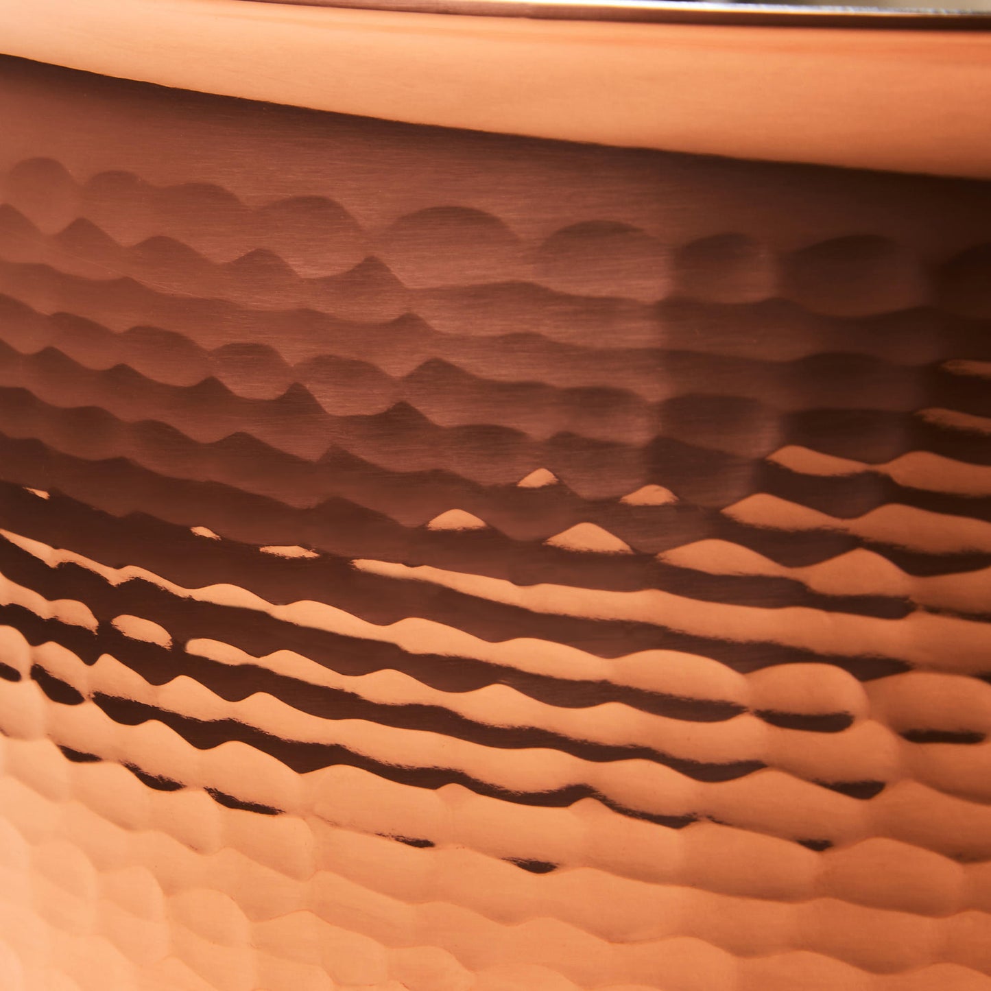 Hammering increases strength and beauty of copper clad with stainless steel saucepot from Ruffoni