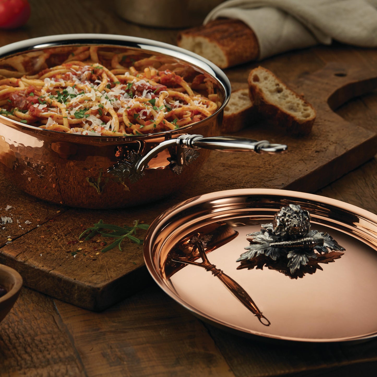 Opus Cupra hammered copper chef pan with stainless steel lining and decorated silver-plated lid knob finial from Ruffoni used to serve Italian spaghetti