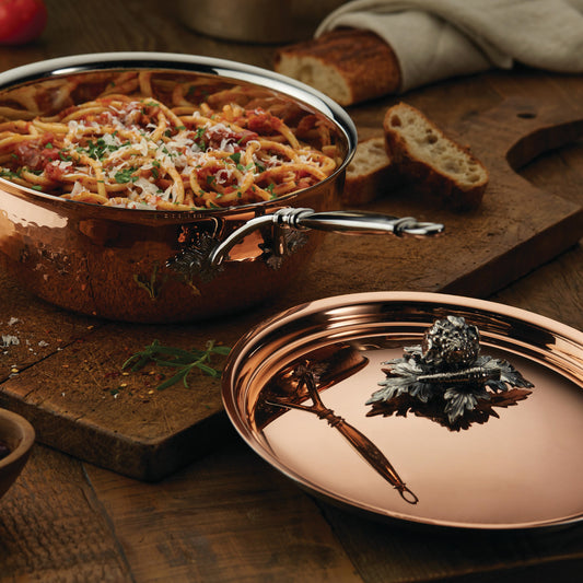 Opus Cupra hammered copper chef pan with stainless steel lining and decorated silver-plated lid knob finial from Ruffoni used to serve Italian spaghetti