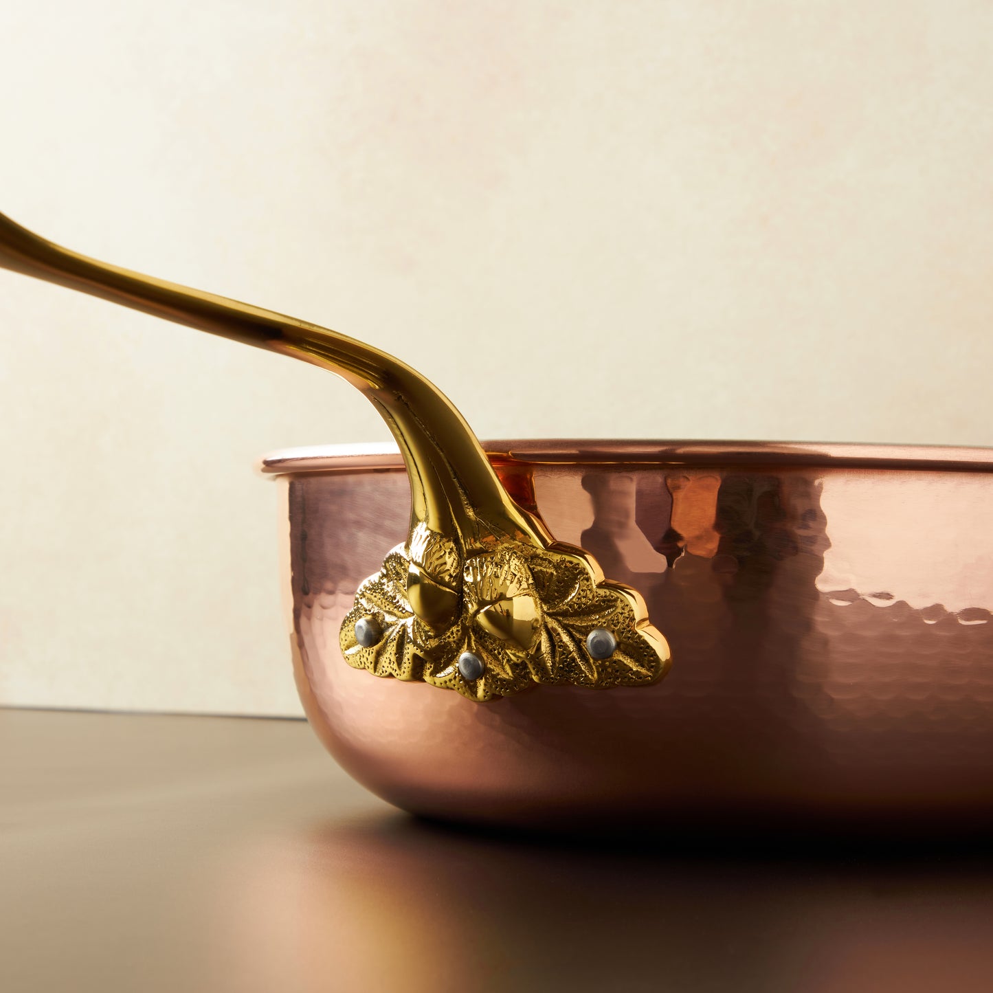 Beautiful bronze stick handle decorated with acorns on Historia cookware by Ruffoni