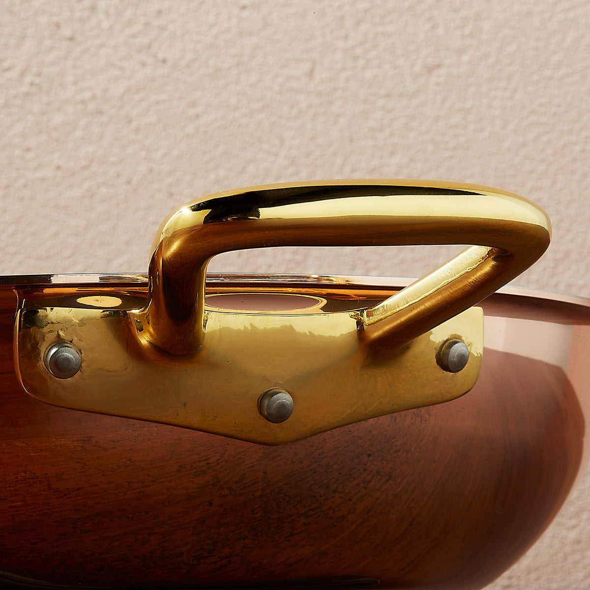 Riveted brass side handle on Ruffoni Olivia Cupra copper cookware