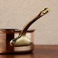Side view of the  brass handle on a Ruffoni Olivia Cupra copper saucepan