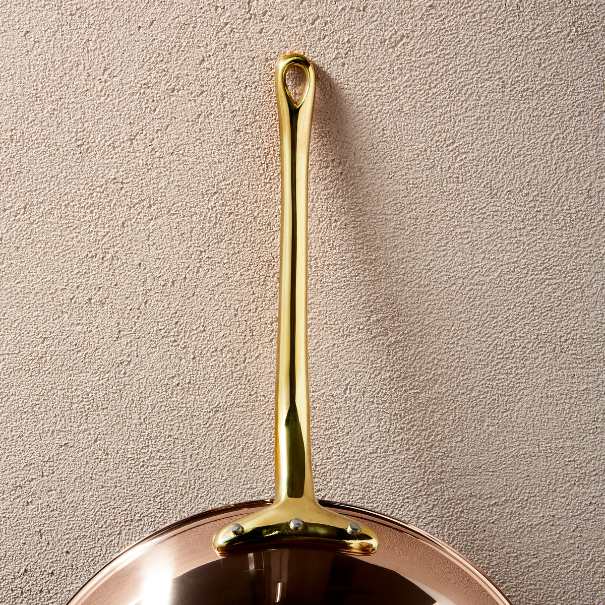 Long brass stick handle riveted to a Ruffoni Olivia Cupra copper frying pan