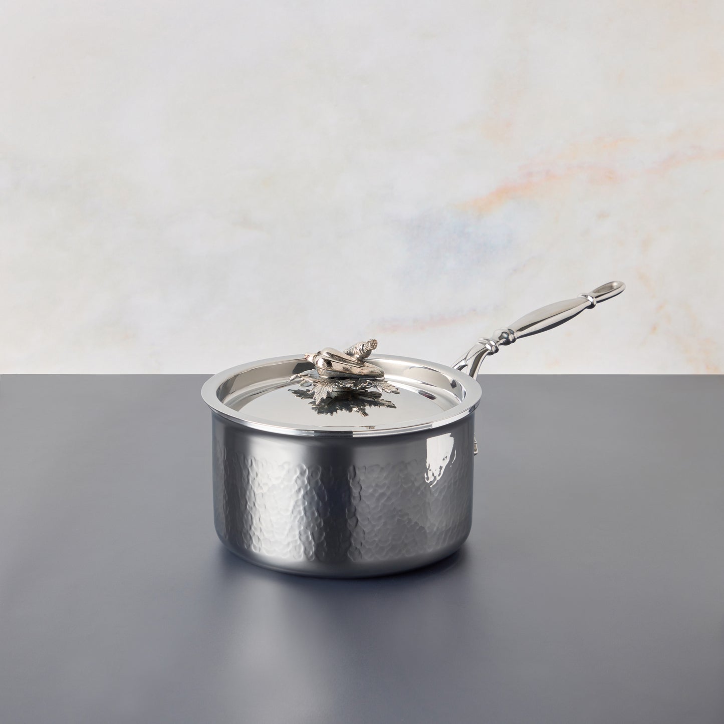 Opus Prima hammered clad stainless steel saucepan with decorated silver-plated lid knob finial from Ruffoni