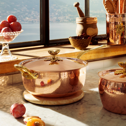 A Ruffoni Historia copper Chef Pan in a sunlit Italian kitchen overlooking a laketown