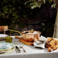 Olivia Cupra copper Chef Pan on a linen tablecloth