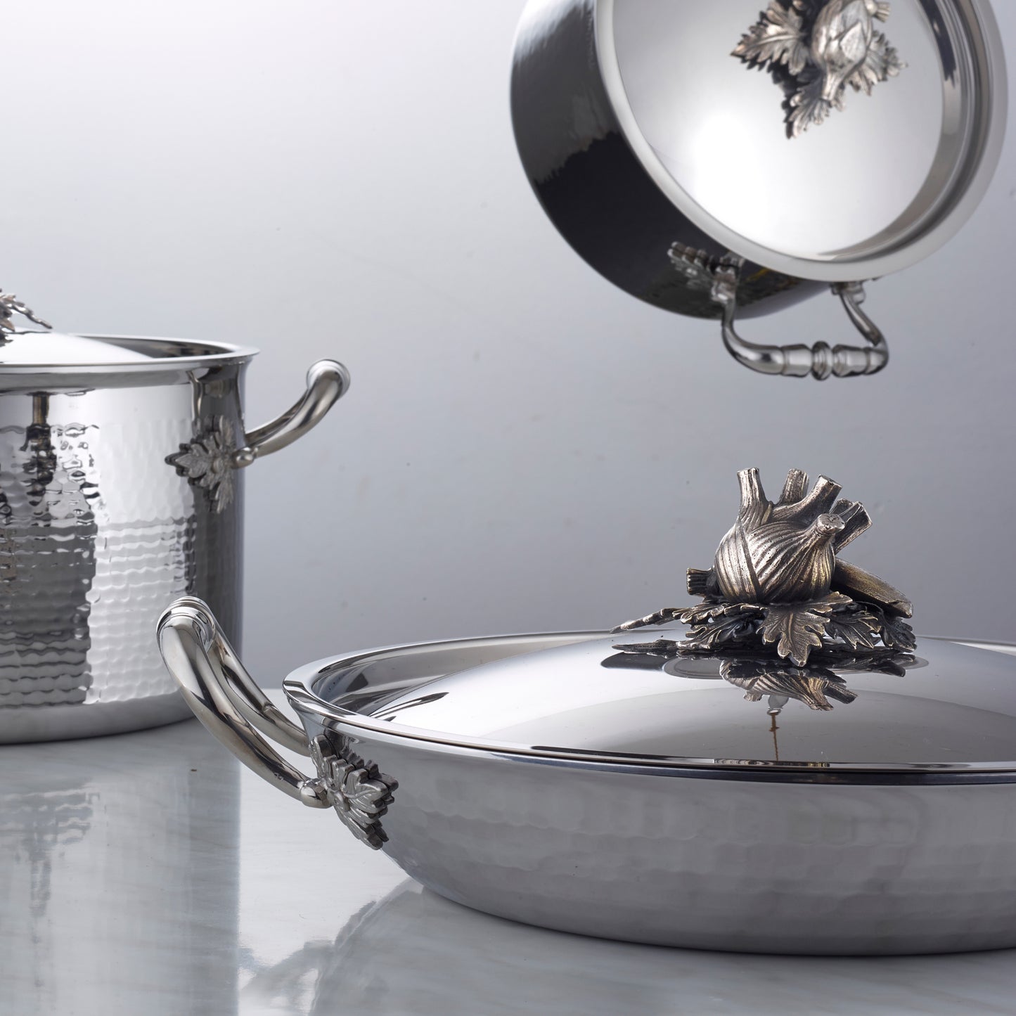 Opus Prima hammered clad stainless steel gratin with decorated silver-plated lid knob finial from Ruffon