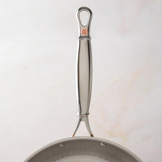 Comfortable stainless steel long stick handle with decorative inlaid copper coin by Ruffoni