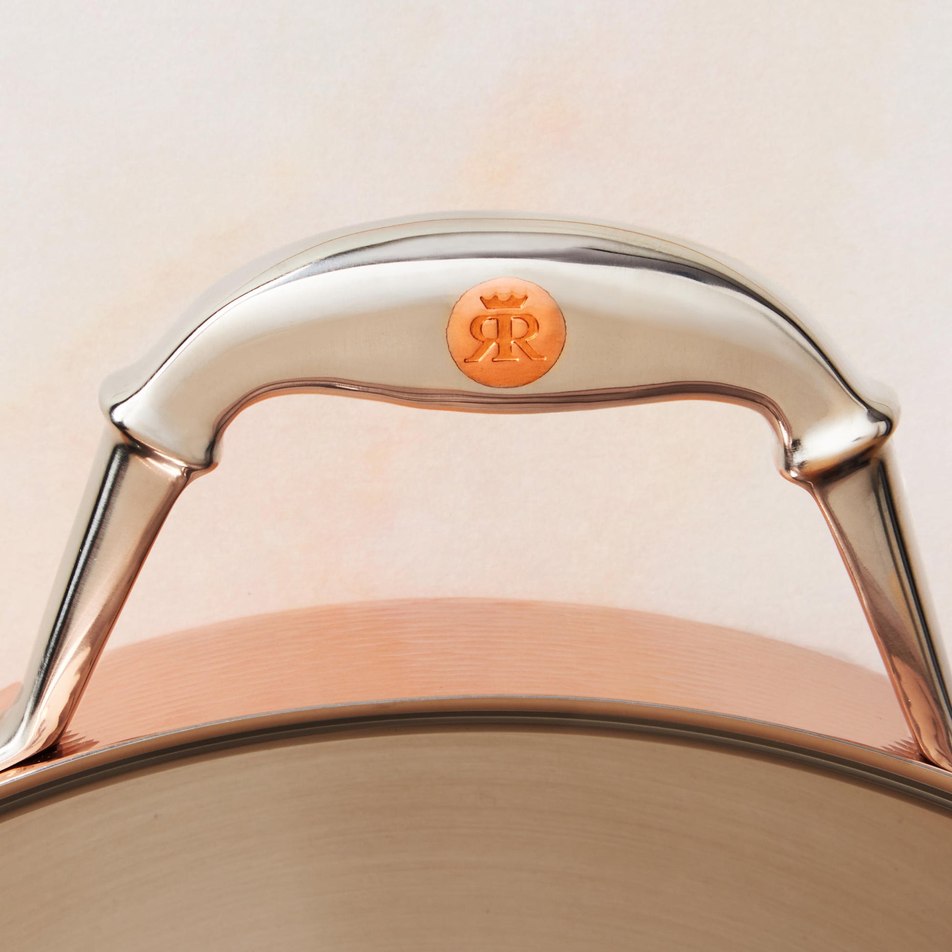 Comfortable stainless steel handle with decorative inlaid copper coing by Ruffoni