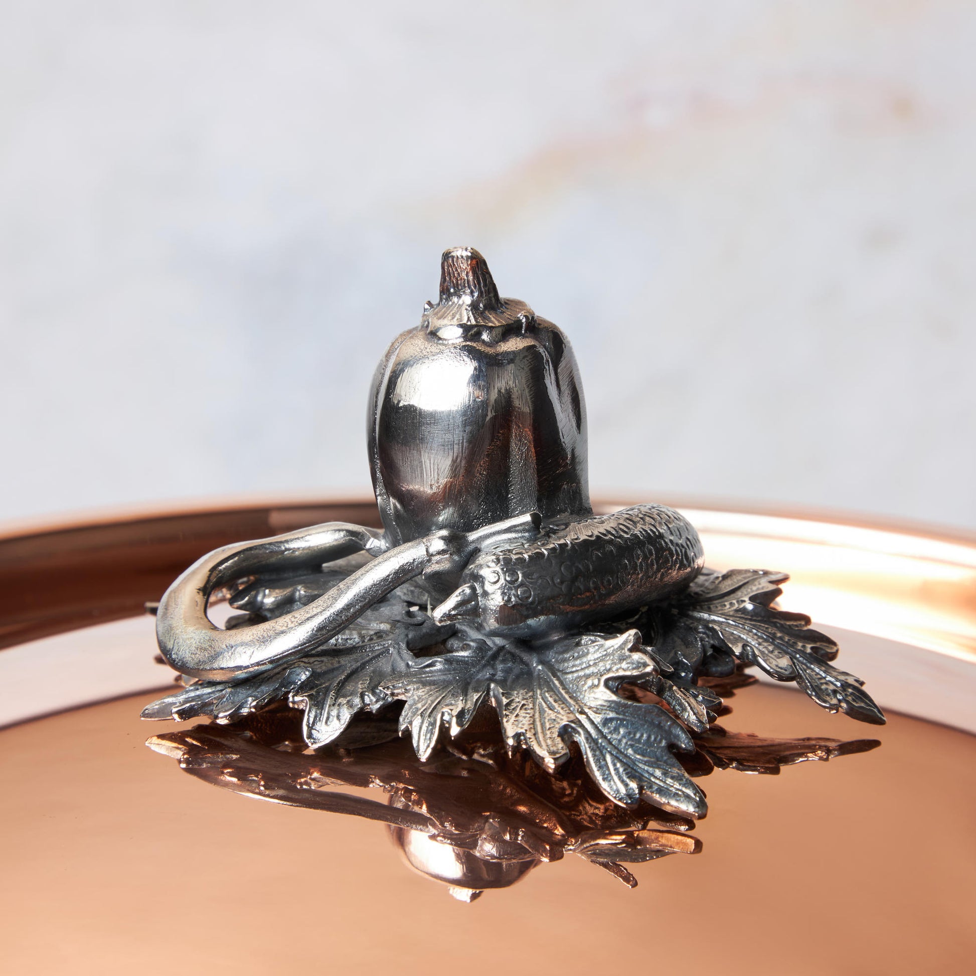 Decorated knob finial representing pepper, cucumber and string bean, cast in solid bronze and silver plated, on Opus Cupra clad copper lid by Ruffoni