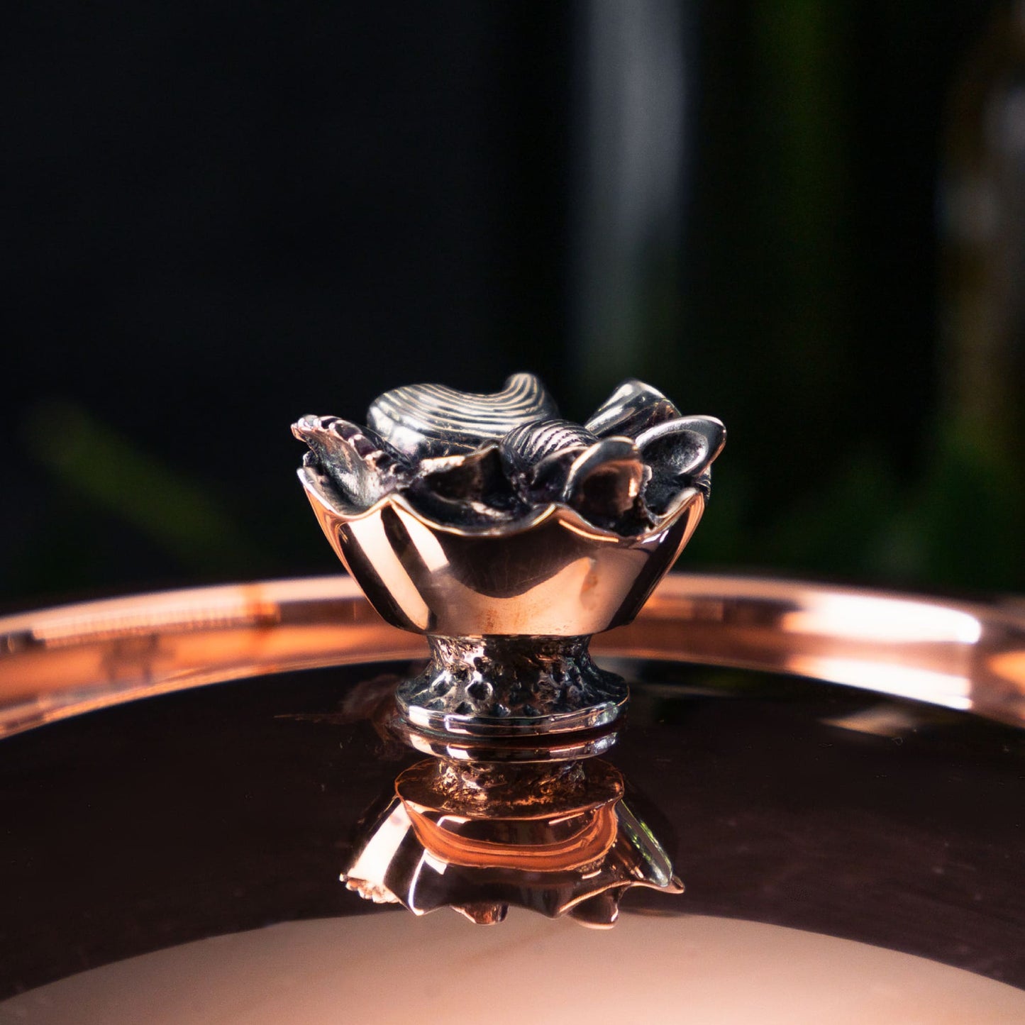 Silver plated, hand cast bronze knob in the shape of a crown filled with pasta, on top of the copper and stainless steel cookware The Pasta Queen by Ruffoni Collection